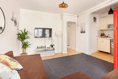 a living room with a couch and a kitchen at Magnificent View Great Location in Istanbul