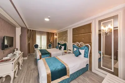 a hotel room with two beds and a television at Marnas Hotels in Istanbul