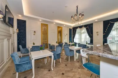 a dining room with tables and blue chairs at Marnas Hotels in Istanbul