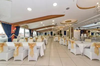 a banquet hall with white tables and chairs at Marnas Hotels in Istanbul