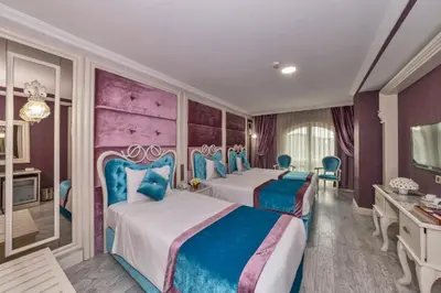 two beds in a room with purple and blue at Marnas Hotels in Istanbul