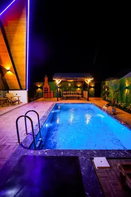 a large swimming pool at night with lights on it at Zeyno Sapanca in Sapanca
