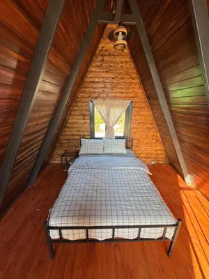 two beds in a room in a attic at Shadeoffgreenbungalow