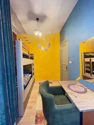 a room with a table and a yellow wall at Taksim Square home in Istanbul