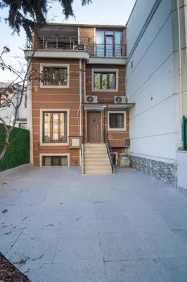 a house with a staircase leading to the front door at Cozy 1BR with Inviting Balcony in Beylikduzu