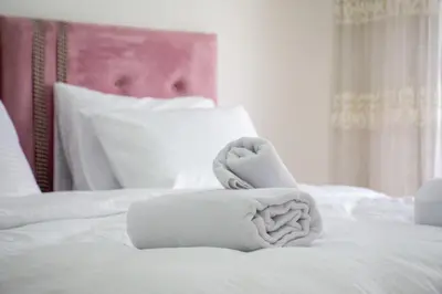 a bed with white towels on top of it at Cozy 1BR & Sofabed with Two Inviting Balconies in Beylikduzu