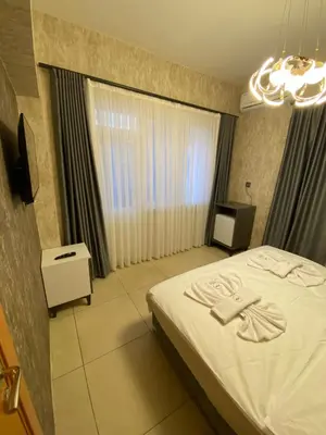a bedroom with a white bed and a window at Royal Fsm Suites in Istanbul