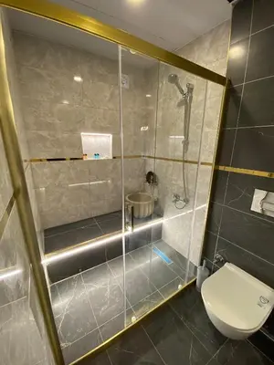 a bathroom with a shower and a toilet at Royal Fsm Suites in Istanbul