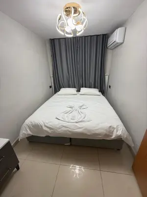 a bedroom with a white bed with a chandelier at Royal Fsm Suites in Istanbul