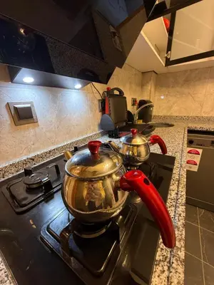 two tea pots on a stove in a kitchen at Royal Fsm Suites in Istanbul