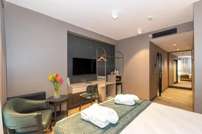 a hotel room with a bed and a desk and a computer at QUİ Hotel&SPA in Istanbul
