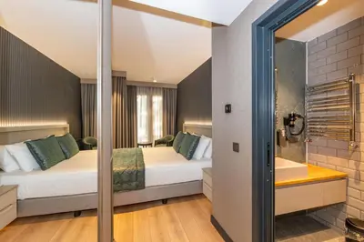 a hotel room with two beds and a bathtub at QUİ Hotel&SPA in Istanbul