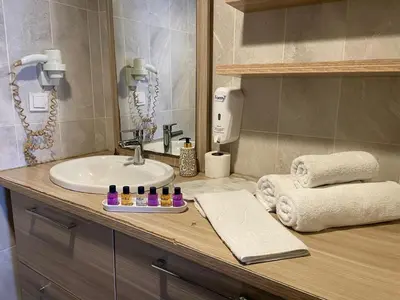a bathroom with a sink and a counter with towels at Ser Suite Apart Hotel in Esenyurt