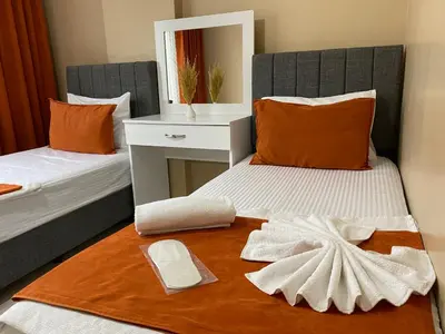 a bedroom with two beds and a mirror on the floor at Ser Suite Apart Hotel in Esenyurt