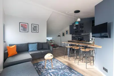 a living room with a couch and a kitchen at Modern Duplex with Large Terrace in Cihangir in Istanbul
