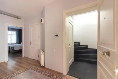a hallway with stairs and a door to a room at Modern Duplex with Large Terrace in Cihangir in Istanbul