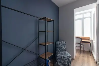 a room with a blue wall with a book shelf at Modern Duplex with Large Terrace in Cihangir in Istanbul