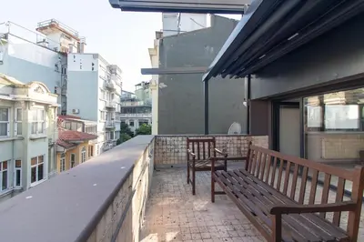 two benches sitting on the balcony of a building at Modern Duplex with Large Terrace in Cihangir in Istanbul