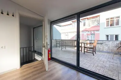 a room with a sliding glass door with a balcony at Modern Duplex with Large Terrace in Cihangir in Istanbul