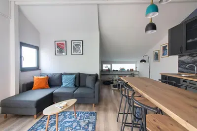 a living room with a couch and a table at Modern Duplex with Large Terrace in Cihangir in Istanbul