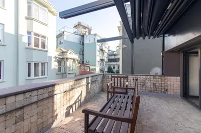 two benches sitting on the balcony of a building at Modern Duplex with Large Terrace in Cihangir in Istanbul