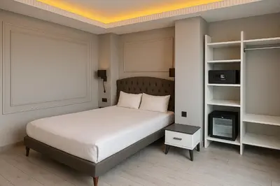 a bedroom with a bed and a book shelf at Loft Airport Hotel in Arnavutköy