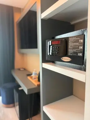 a microwave oven on a shelf in a room at Loft Airport Hotel in Arnavutköy