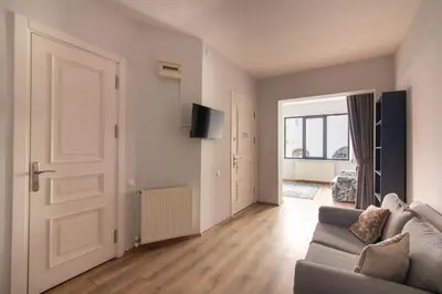 a living room with a couch and a door at Modern and Cozy 2BR in Vibrant Cihangir in Istanbul