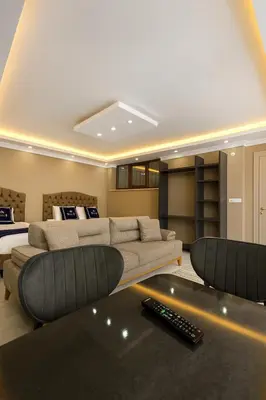 a living room with a couch and a bed at Loft House Studio in Arnavutköy