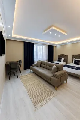 a living room with a couch and a bed at Loft House Studio in Arnavutköy