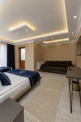 a bedroom with a large bed and a couch at Loft House Studio in Arnavutköy
