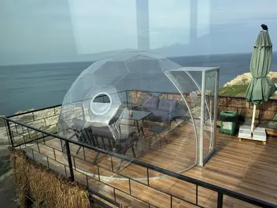 a dome house on a deck with the ocean at Marina Boutique Hotel Istanbul Airport in Karaburun