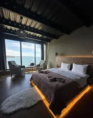 a bedroom with a large bed and a large window at Marina Boutique Hotel Istanbul Airport in Karaburun