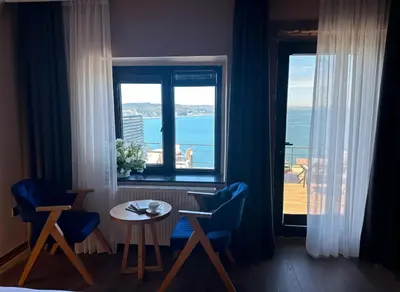 a room with a table and chairs and a window at Marina Boutique Hotel Istanbul Airport in Karaburun