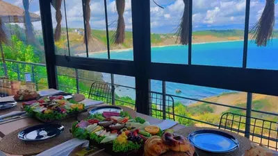 a table with food on it with a view of the ocean at Marina Boutique Hotel Istanbul Airport in Karaburun