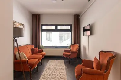 a waiting room with orange chairs and a window at Eclectic 1BR with Charm in the Heart of Cihangir in Istanbul