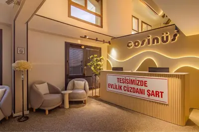 a waiting room with two chairs and a sign at Cosinüs Airport Hotel in Arnavutköy
