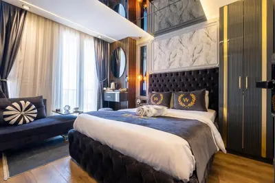 a bedroom with a large bed and a couch at The Wind Beşiktaş in Istanbul