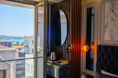 a room with a balcony with a mirror at The Wind Beşiktaş in Istanbul