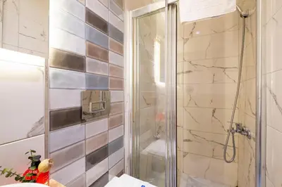 a bathroom with a shower with a glass door at The Wind Beşiktaş in Istanbul
