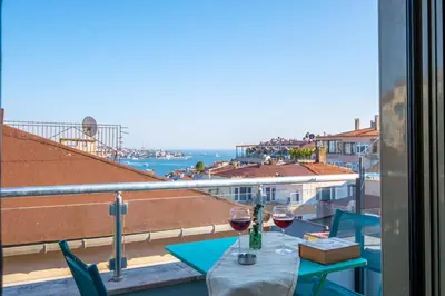 a table with two glasses of wine on a balcony at The Wind Beşiktaş in Istanbul