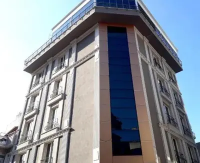 a tall building with a tower on top of it at Tüm Palace Otel in Bandırma