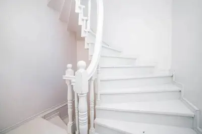 a stairway with white stairs in a room at Private house with 4 separate apartments-for families & friend groups in Istanbul