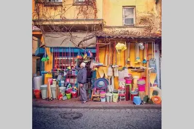 a man standing in front of a shop with a bunch of buckets at Private house with 4 separate apartments-for families & friend groups in Istanbul