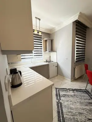 a kitchen with white cabinets and a counter top at Residence 4 in Istanbul