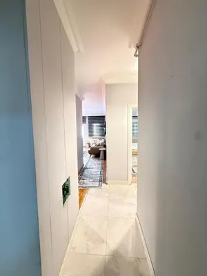 a hallway with white walls and a tile floor at Residence 4 in Istanbul