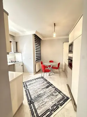 a kitchen and dining room with a table and red chairs at Residence 4 in Istanbul