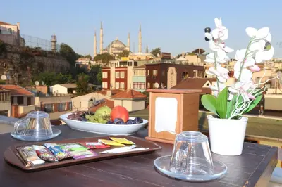 a table with a plate of food and a bowl of fruit at My Holiday Time Hotel in Istanbul