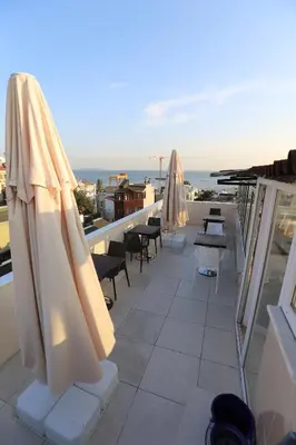 a balcony with umbrellas and tables and chairs at My Holiday Time Hotel in Istanbul