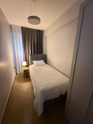 a small bedroom with a bed and a window at Trio Houses in Istanbul